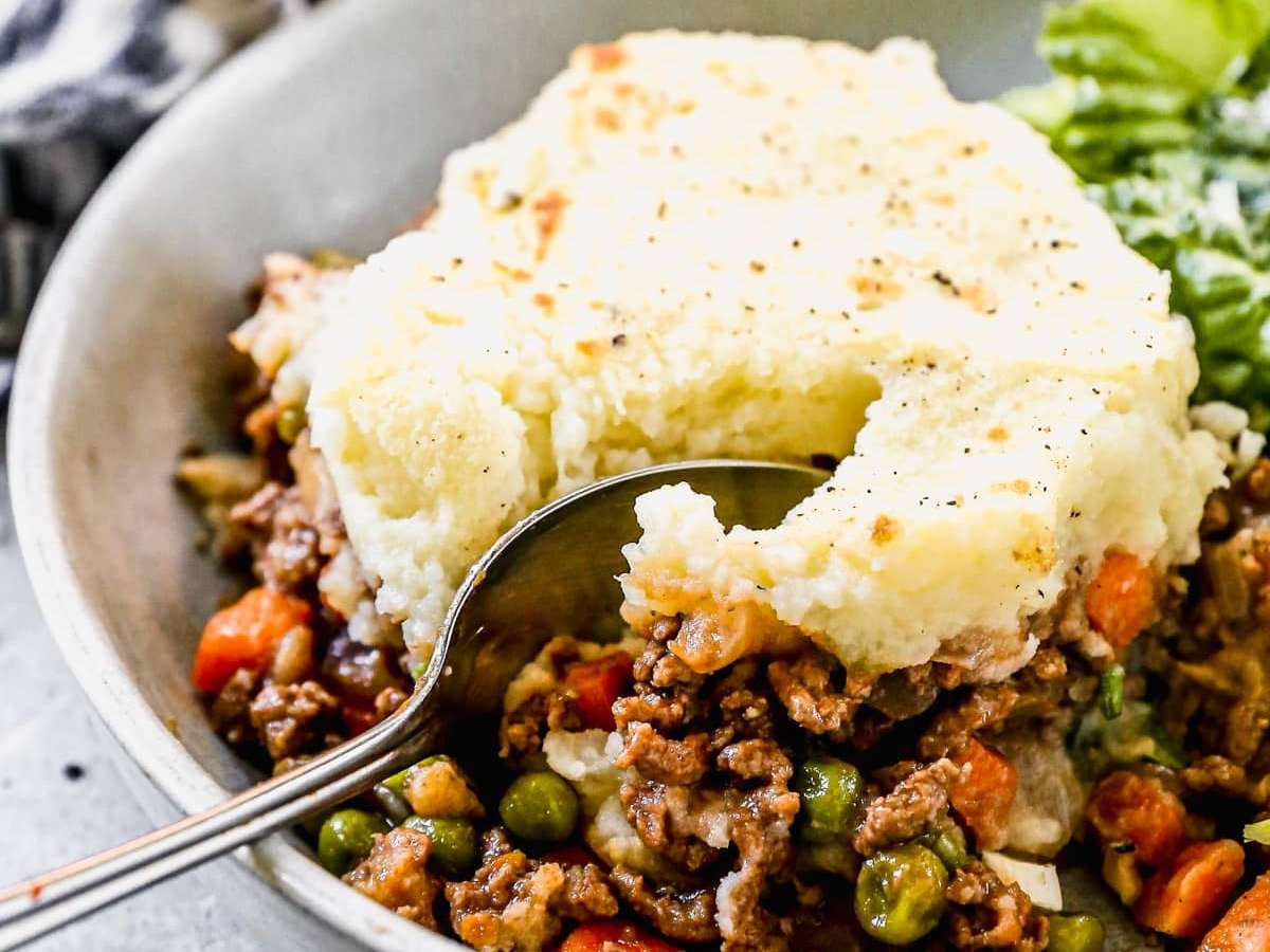 easy shepherds pie topped with mashed potatoes in a bowl with a spoon
