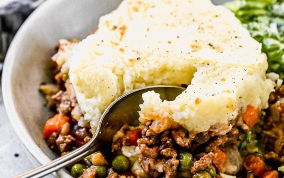 easy shepherds pie topped with mashed potatoes in a bowl with a spoon