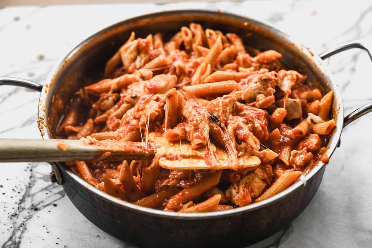 stirring cheese into chicken parmesan pasta