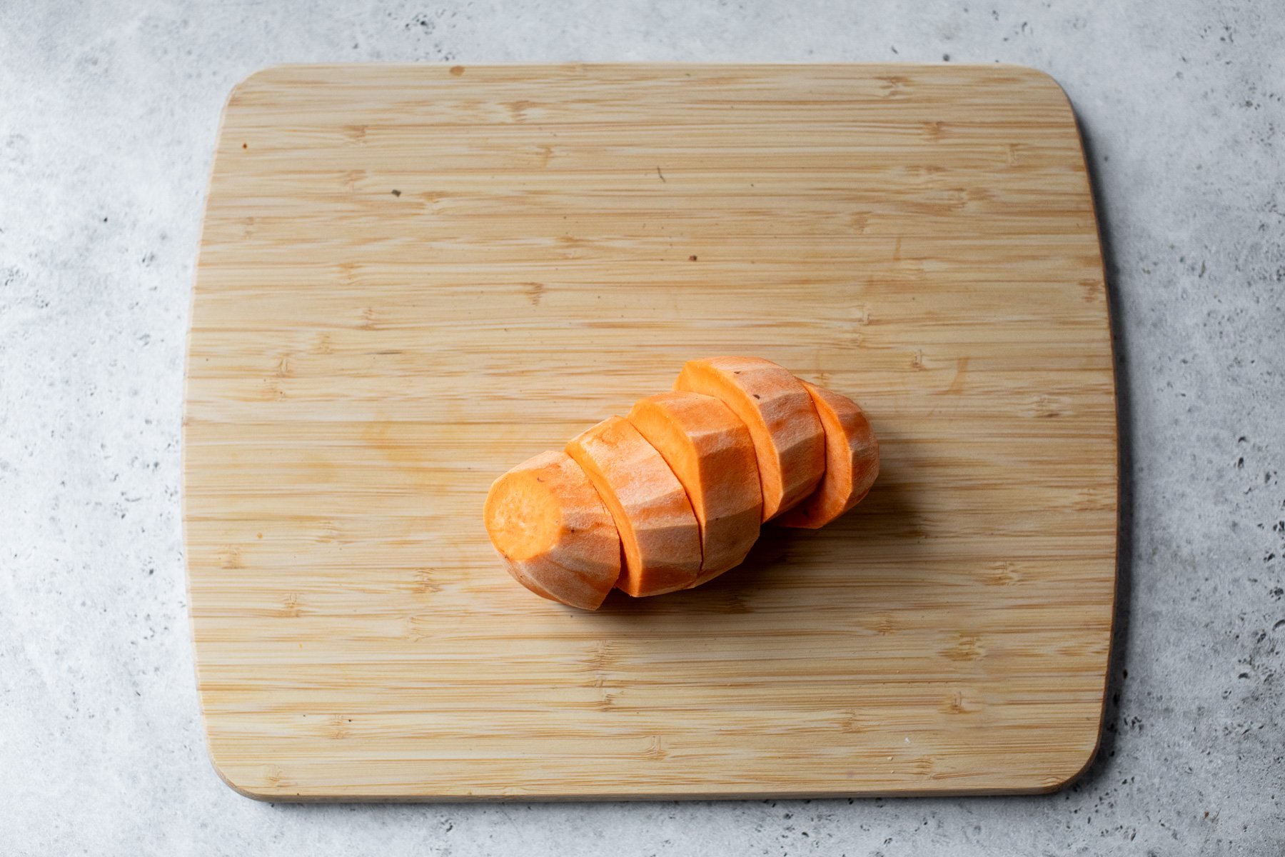 Sliced sweet potato on cutting board