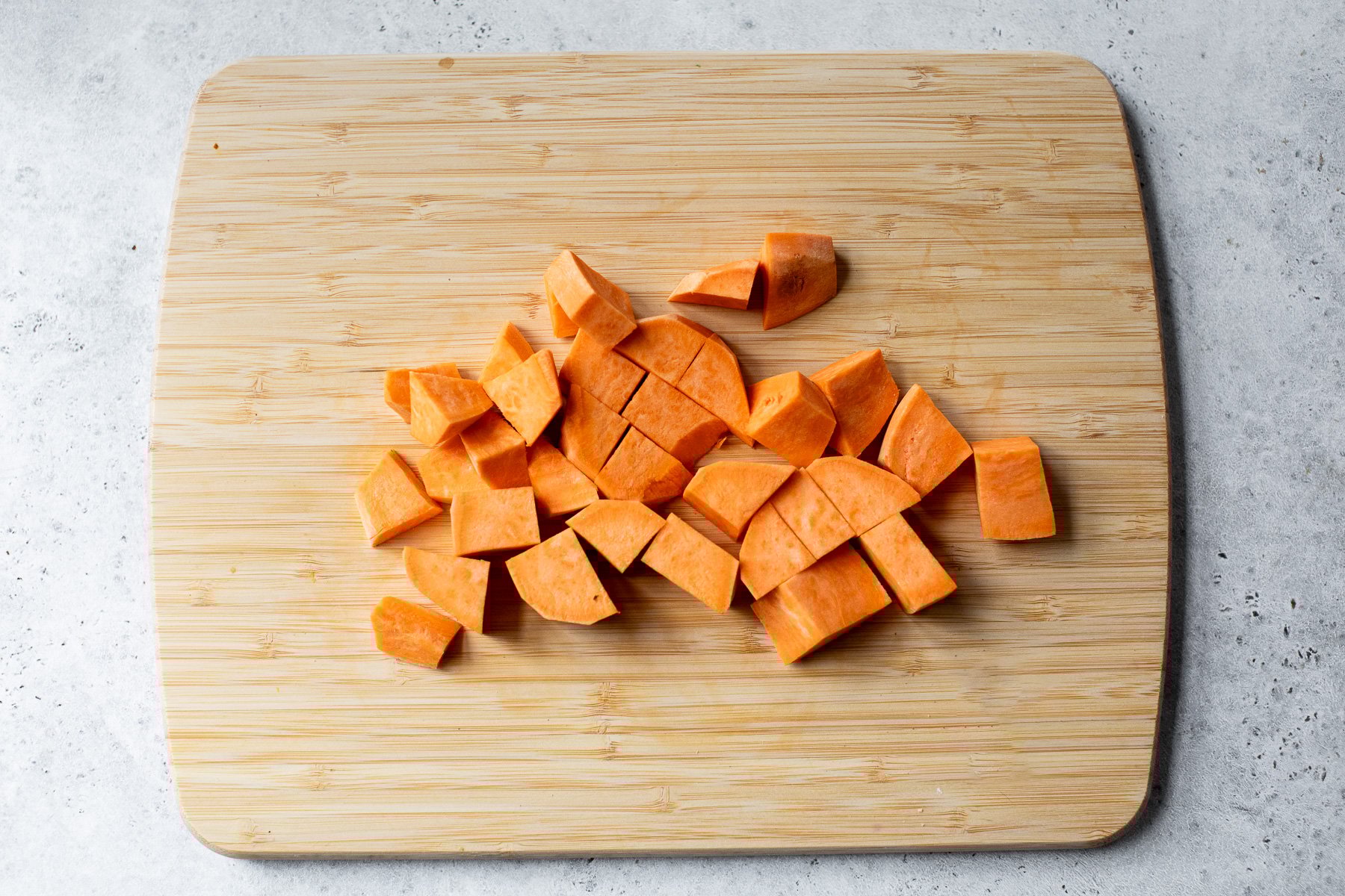 Chunks of sweet potato on cutting board