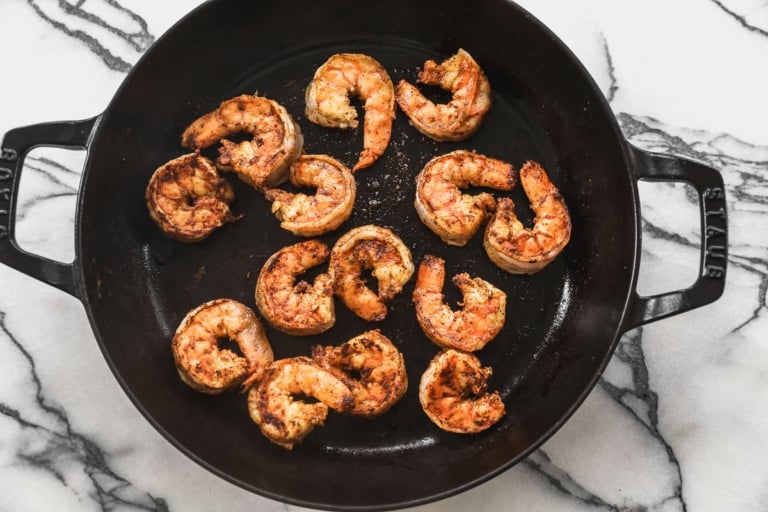 Shrimp cooking in cast iron skillet