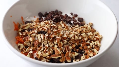 Ingredients for gluten-free carrot cake in mixing bowl