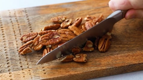 Chopping pecans for gluten-free carrot cake