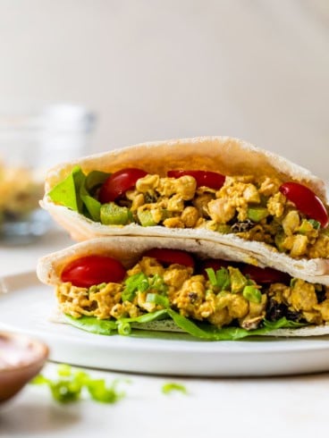 two chickpea salad sandwich halves stacked on plate