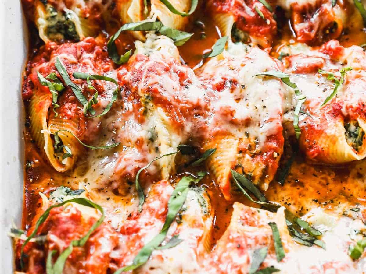 a pan of cheesy stuffed shells with ricotta, spinach and mozzarella