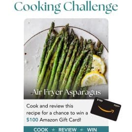 A plate of air fryer asparagus with lemon slices, promoting an April cooking challenge to win a $100 Amazon gift card.