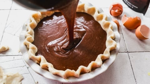 Pouring filling into crust for chocolate chess pie