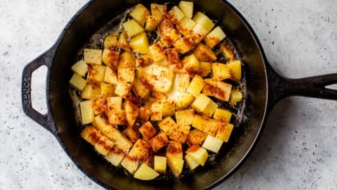 Home fries in skillet after adding butter