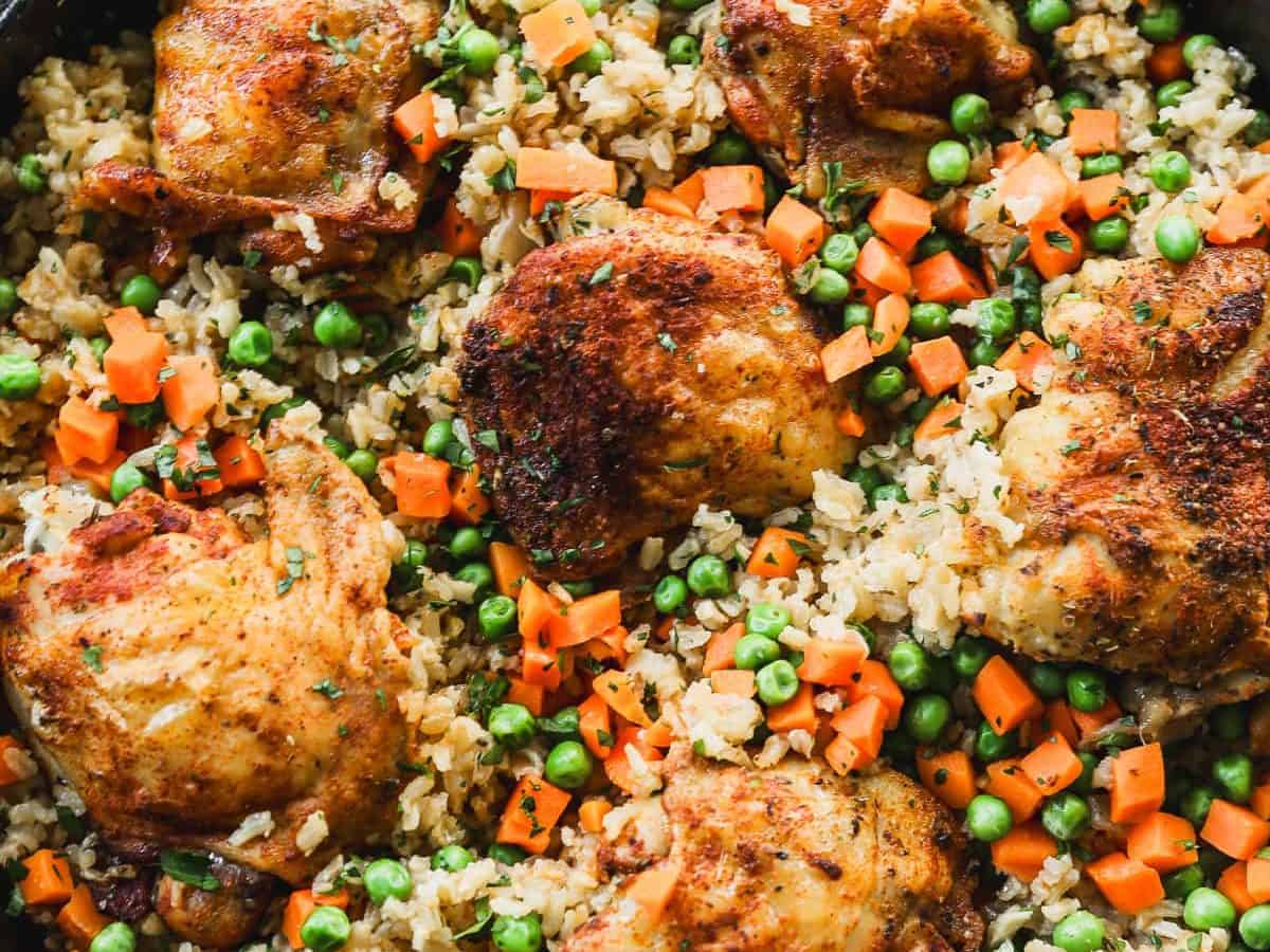 Overhead view of baked chicken and rice in skillet