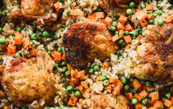 Overhead view of baked chicken and rice in skillet