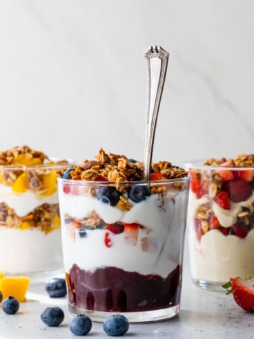 3 glasses with different variations of fruit and yogurt parfaits