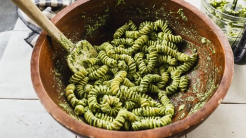 Pasta tossed with pesto in bowl