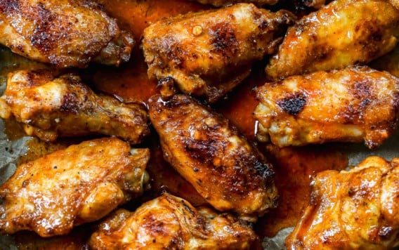 Overhead view of grilled chicken wings with Buffalo sauce