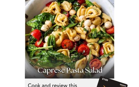Bowl of caprese pasta salad with tomatoes, spinach, and mozzarella; $100 Amazon gift card shown; cooking challenge.