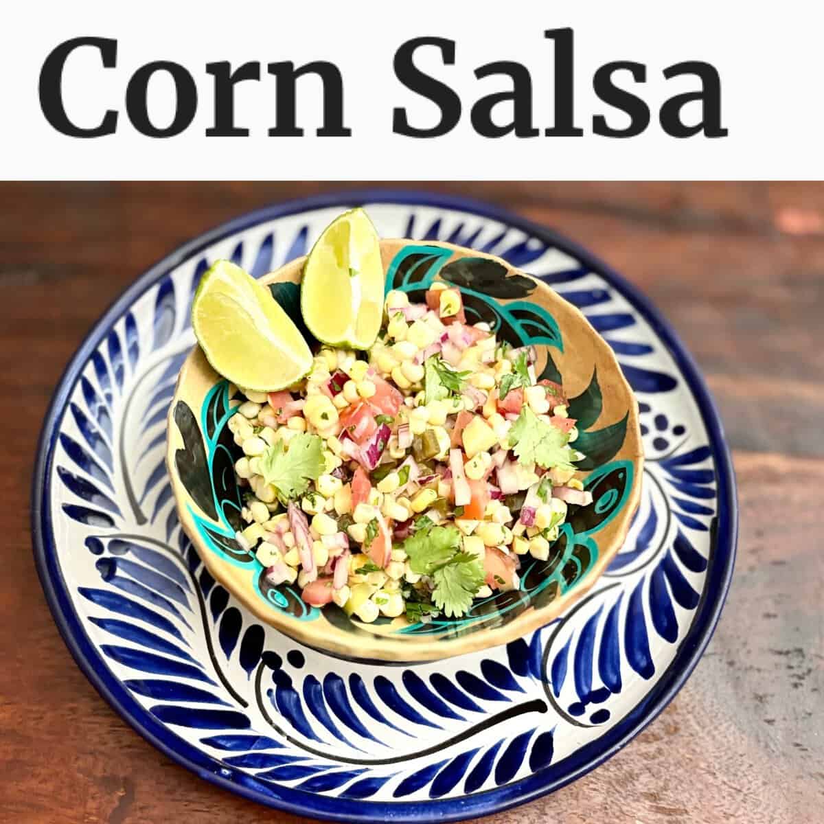 A bowl of corn salsa with lime wedges on a patterned plate, with "Corn Salsa" text above.