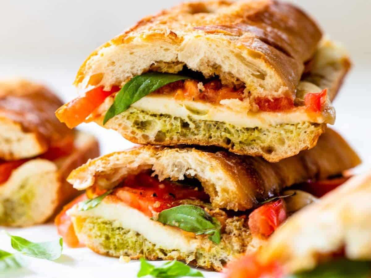 Two caprese sandwiches stacked on top of each other