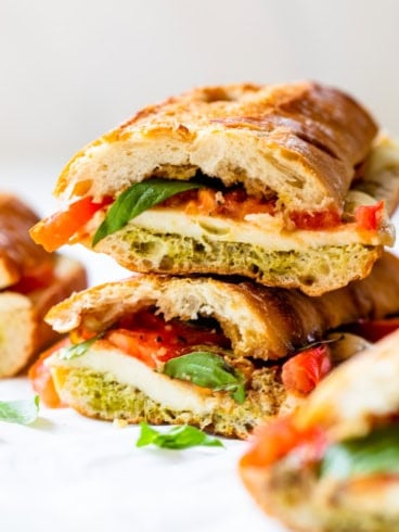 Two caprese sandwiches stacked on top of each other