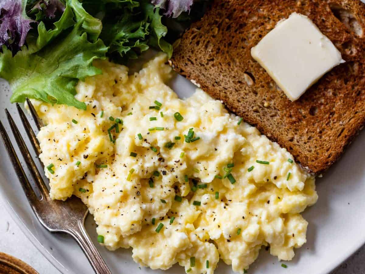 Cottage cheese eggs on plate with toast and salad