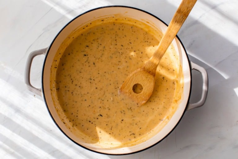 Stirring cream sauce in Dutch oven