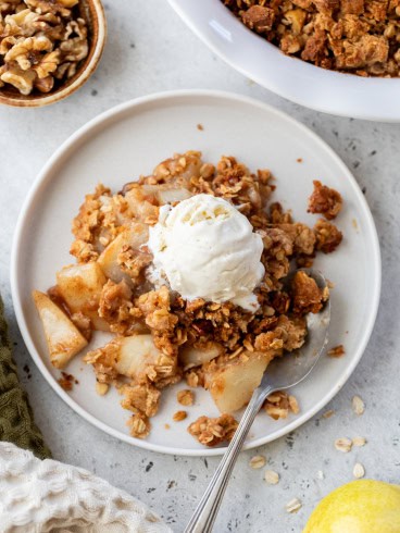 Pear crisp recipe on plate with vanilla ice cream
