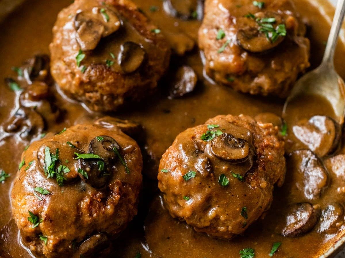 Salisbury steak in skillet with gravy