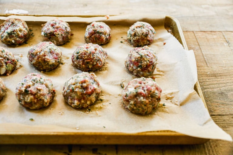 Unbaked Swedish meatballs on sheet pan