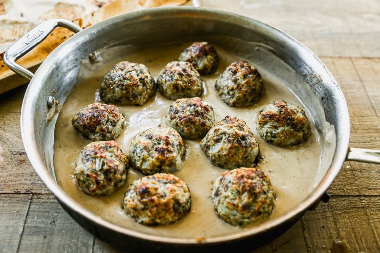 Baked Swedish meatballs in skillet of creamy gravy