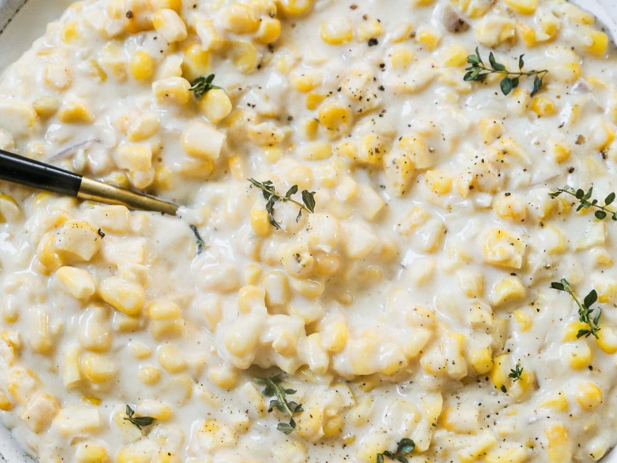 Creamed corn in serving dish with spoon