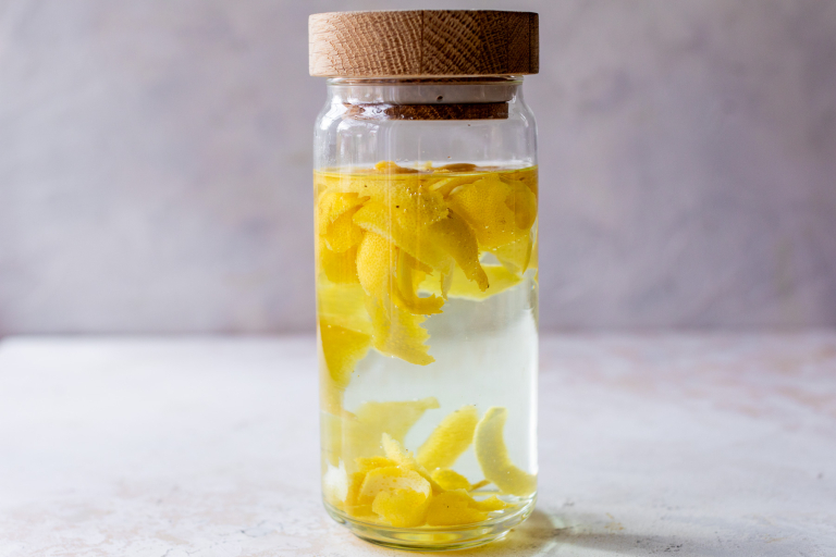Lemon peels and vodka in jar