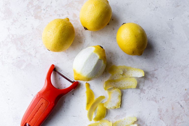 Peeling lemon to remove rind