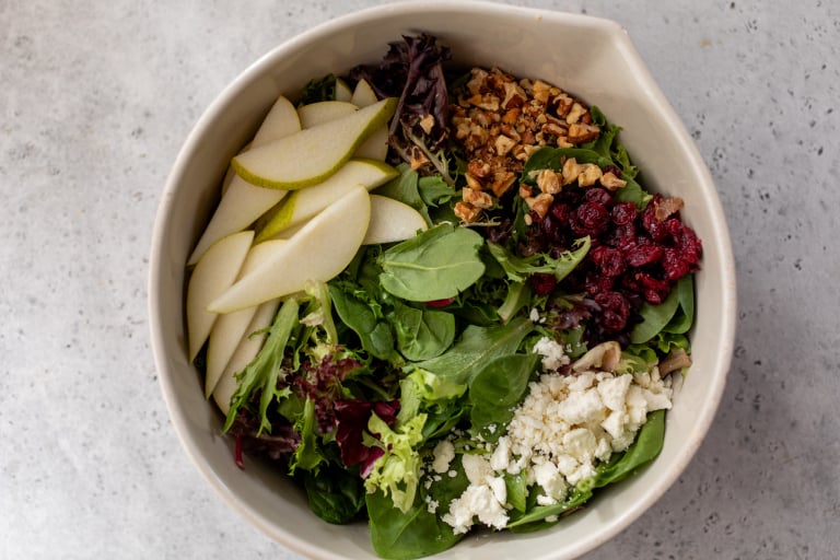 Ingredients for pear salad in mixing bowl