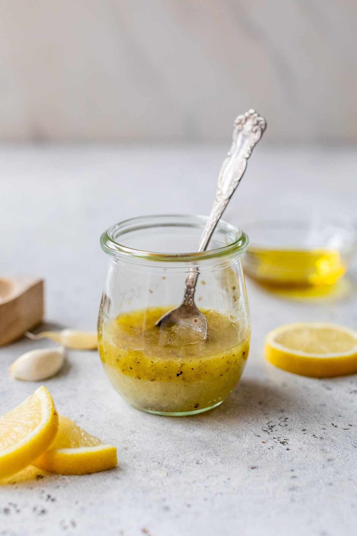 Lemon vinaigrette in glass jar with spoon