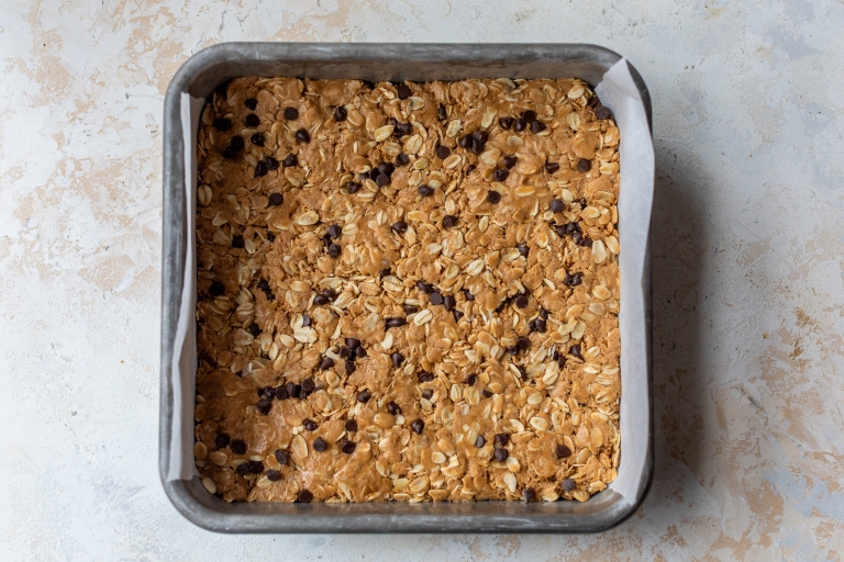 Peanut butter protein bars in pan before slicing