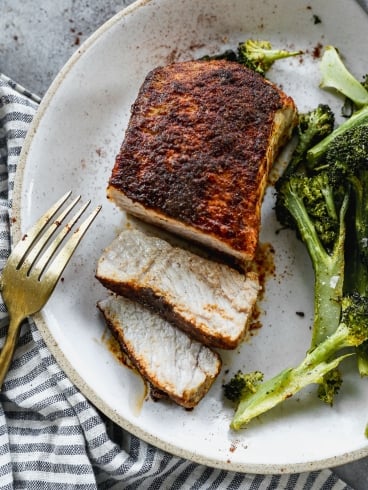 Baked pork chops on plate with broccoli
