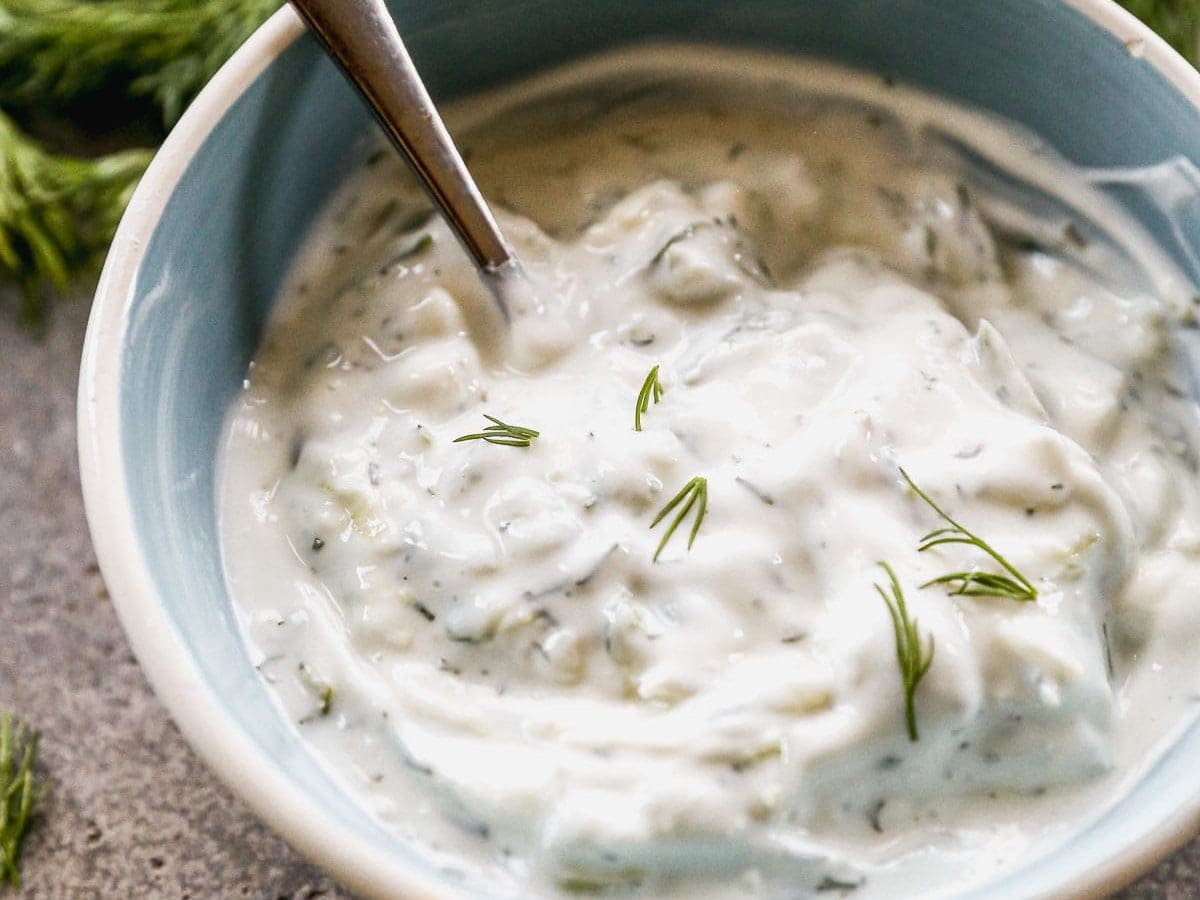 Homemade tzatziki sauce in bowl with spoon