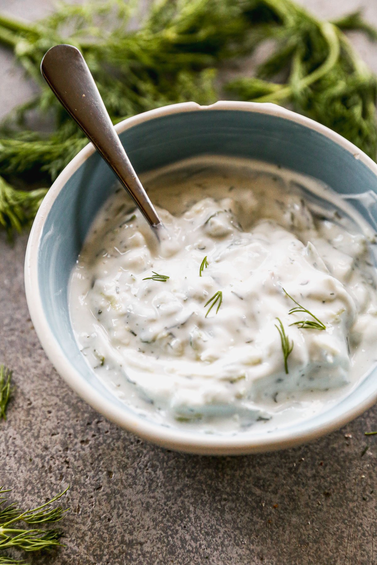 Homemade tzatziki sauce in bowl with spoon