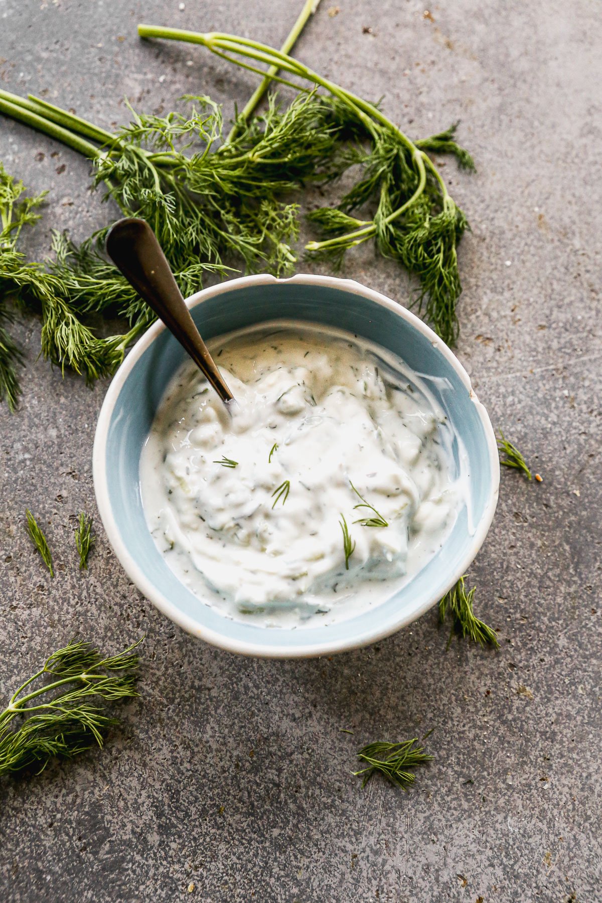 Bowl of homemade tzatziki sauce with fresh dill