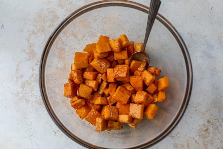 Bowl of butternut squash cubes with seasonings