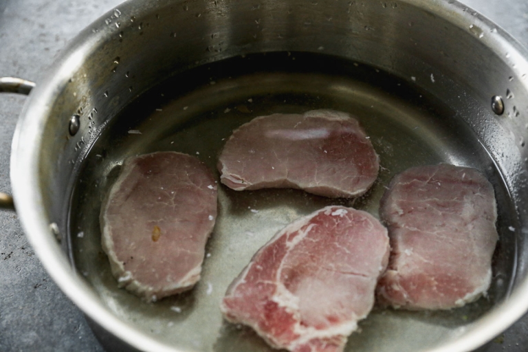 Pork chops soaking in brine