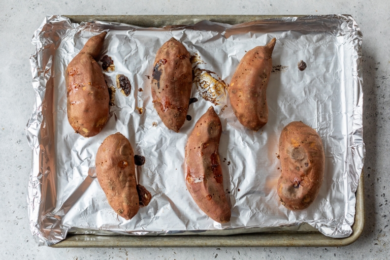 Baked sweet potatoes on baking sheet
