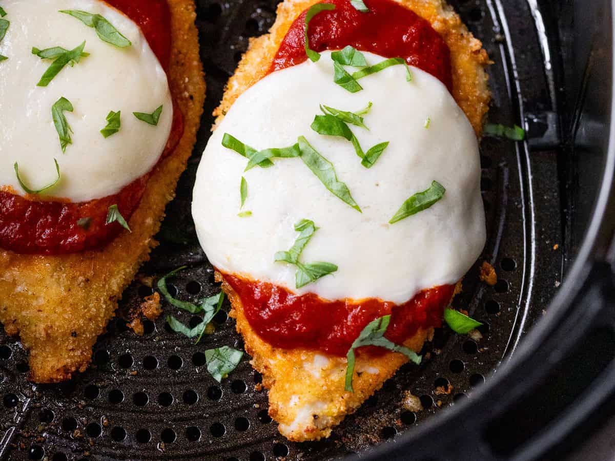 Air fryer chicken Parmesan in air fryer basket.