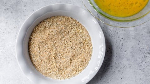 Breadcrumb mixture in ceramic pie plate.