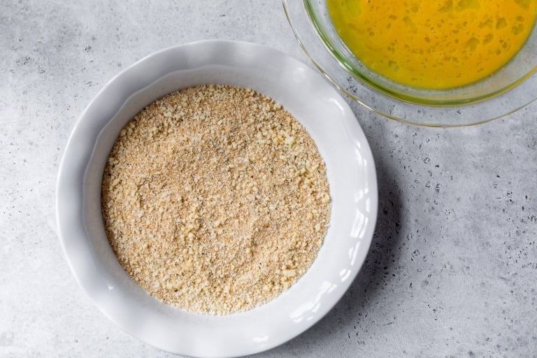 Breadcrumb mixture in ceramic pie plate.