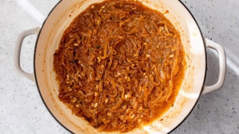 Caramelized onions with garlic and thyme in Dutch oven.