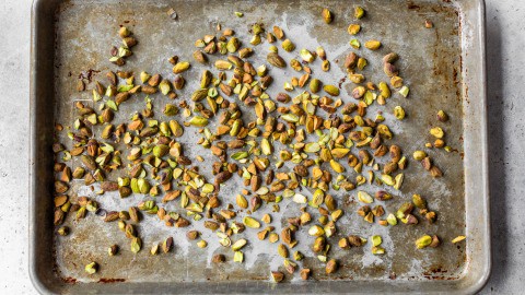 Pistachios on baking sheet.