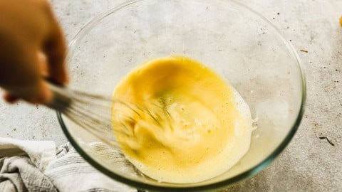 Whisking eggs in glass bowl.