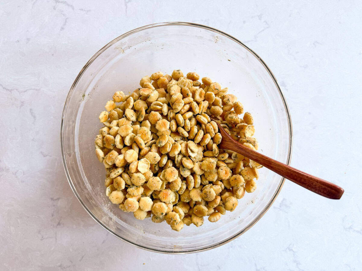 a bowl of crackers tossed with oil and ranch seasoning