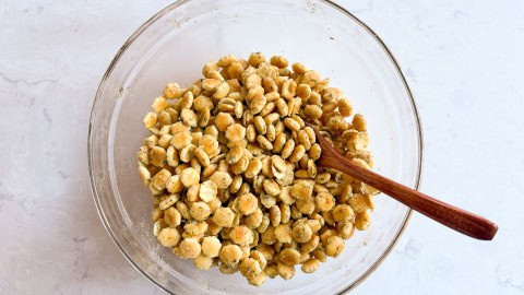 a bowl of crackers tossed with oil and ranch seasoning