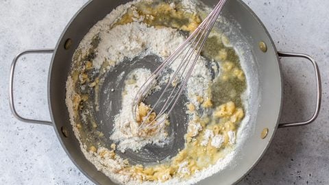 Whisk in skillet with roux.